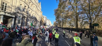 A peaceful protest with people marching down a city street.