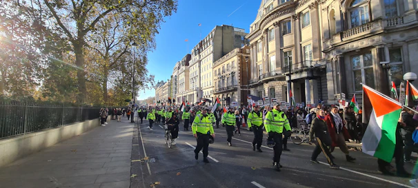 Supporters holding signs and flags during a street march.