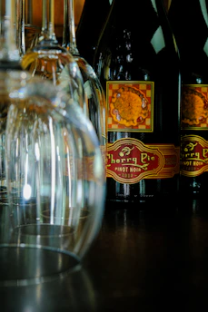 Close-up of financial charts and wine bottles representing winery business analysis