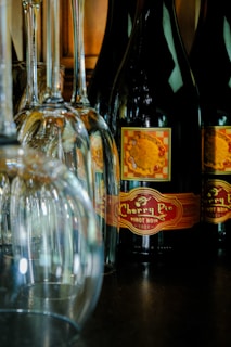 Several wine glasses are positioned alongside a bottle of Cherry Pie Pinot Noir, with a label featuring a pie image. The setup creates an elegant and inviting atmosphere.