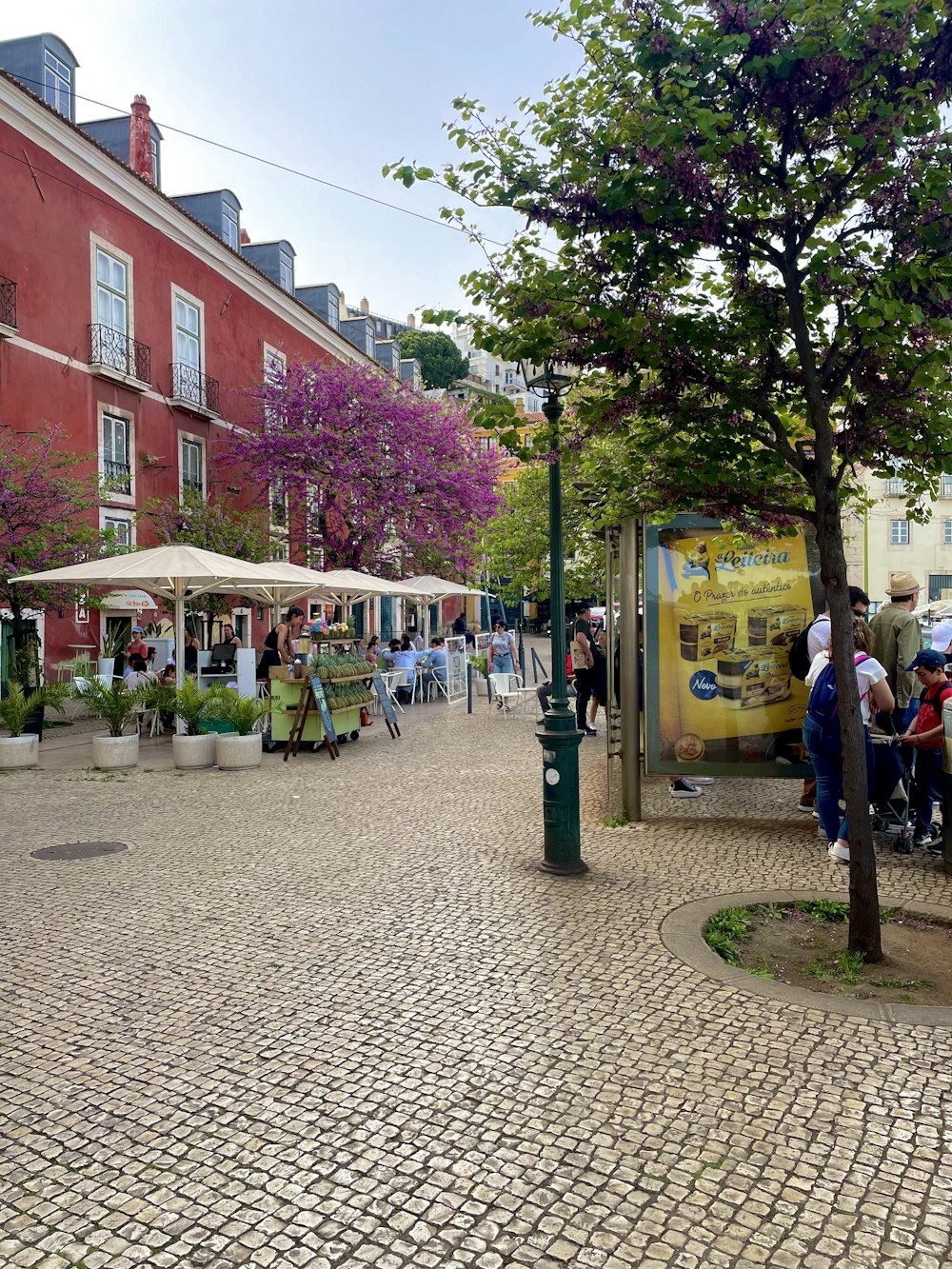 a group of people standing on a cobblestone street