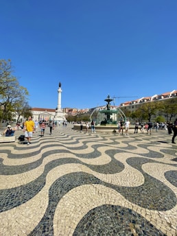 a group of people standing around a fountain
