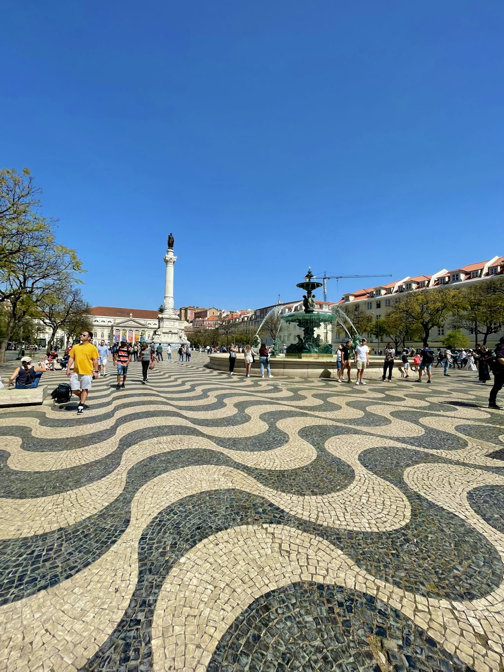 a group of people standing around a fountain