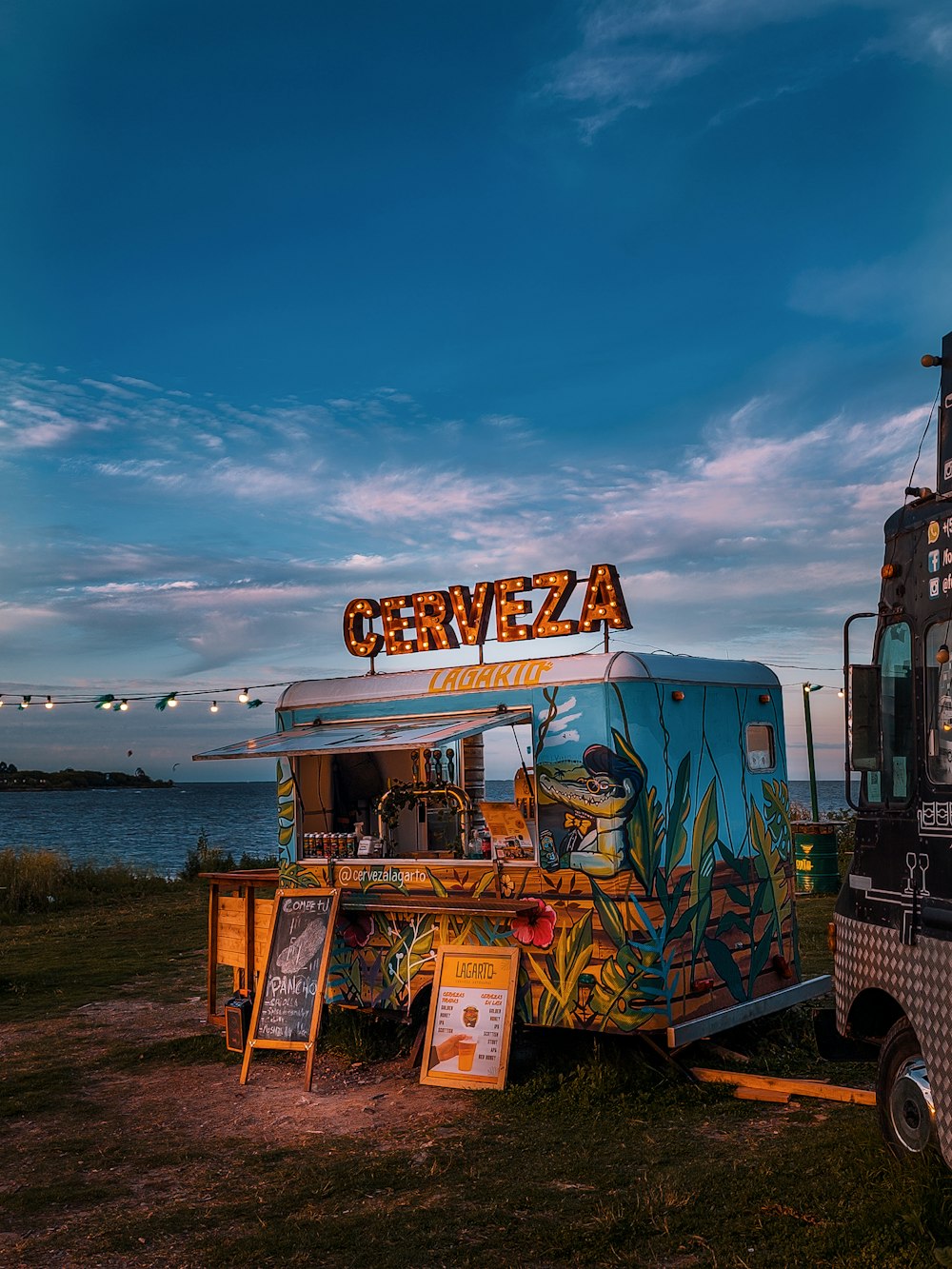 a food truck parked next to a body of water