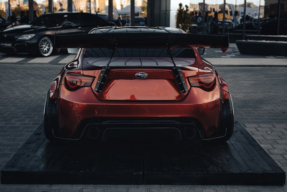 a red sports car parked in a parking lot