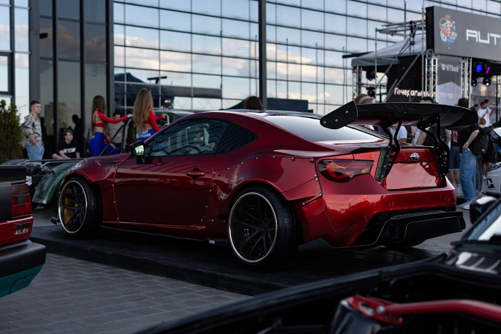 a red sports car parked in front of a building