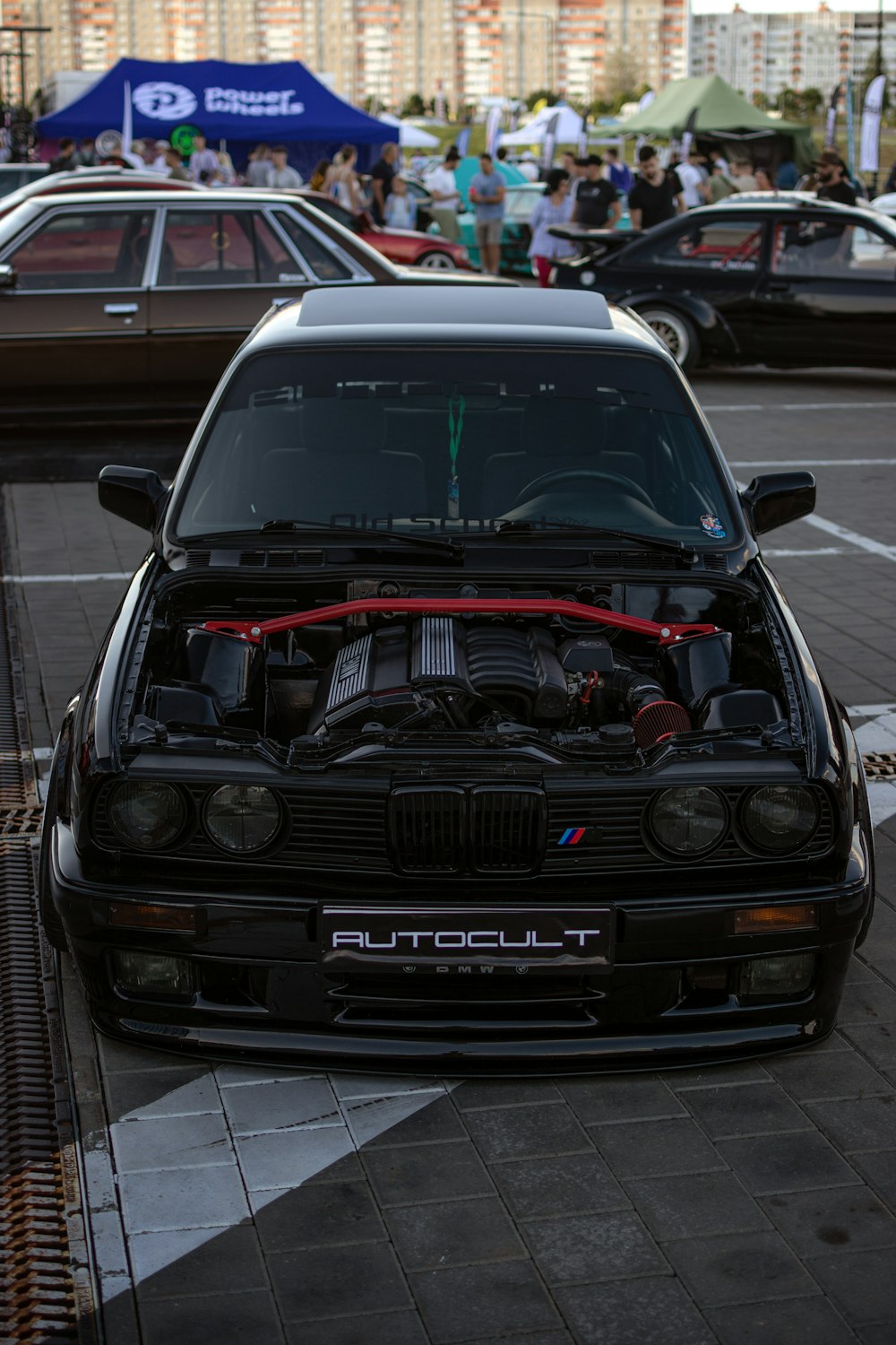 a car parked in a parking lot with its hood open