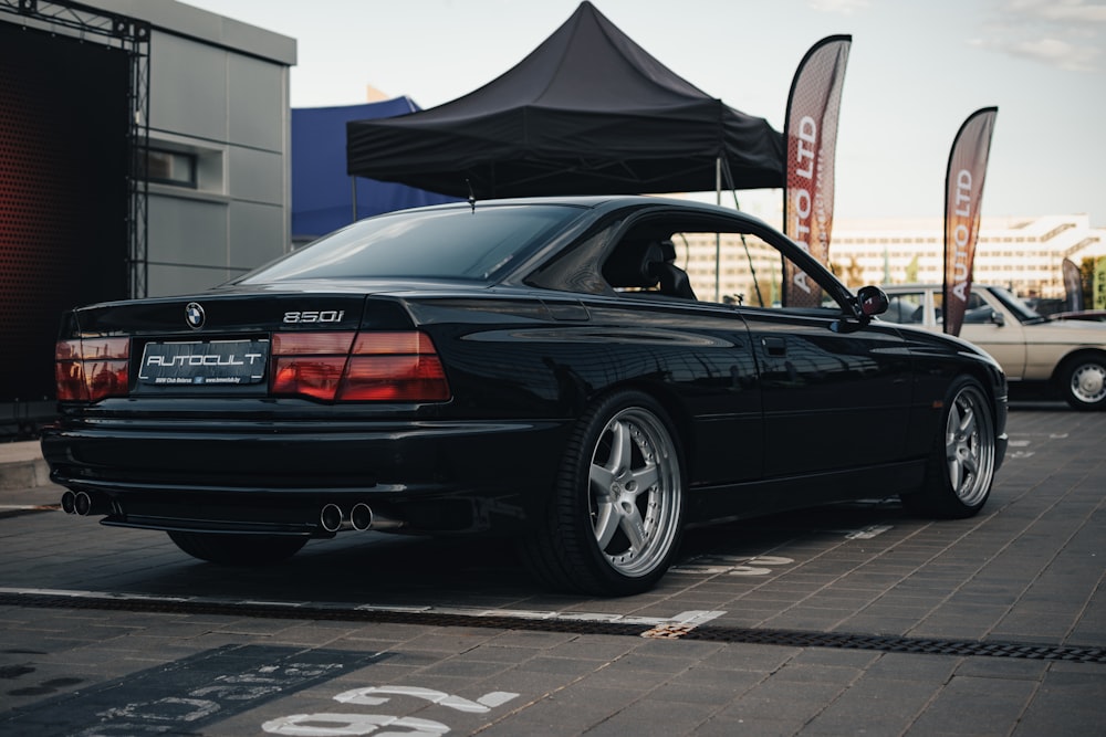 a black car parked on the side of the road