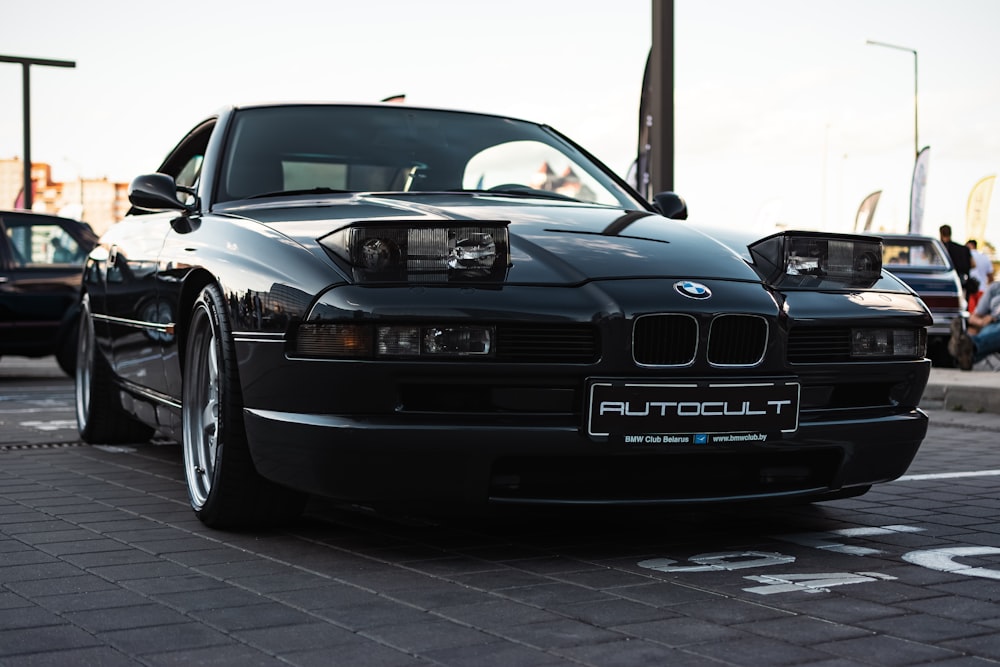 a black car parked on the side of the road