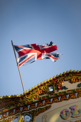 a british flag flying on top of a carnival ride