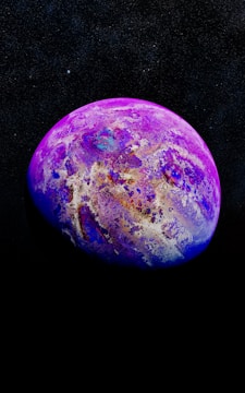 A vividly colored planet-like sphere with swirling patterns of purple, blue, and white, set against a dark, star-filled background. The surface appears textured and abstract, with intricate details resembling a cosmic landscape.