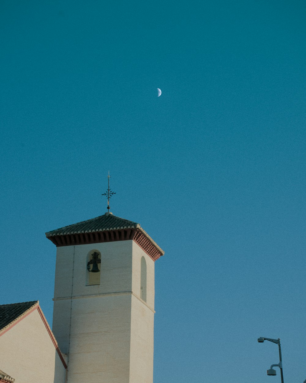 a church steeple with a moon in the sky