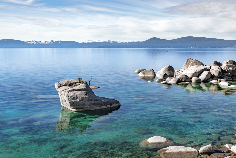 a large rock in the middle of a body of water