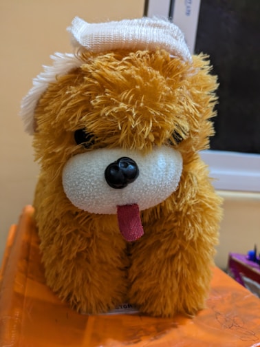 A cozy plush dog shaped like a golden retriever, perfect for cuddling or storing pencils.
