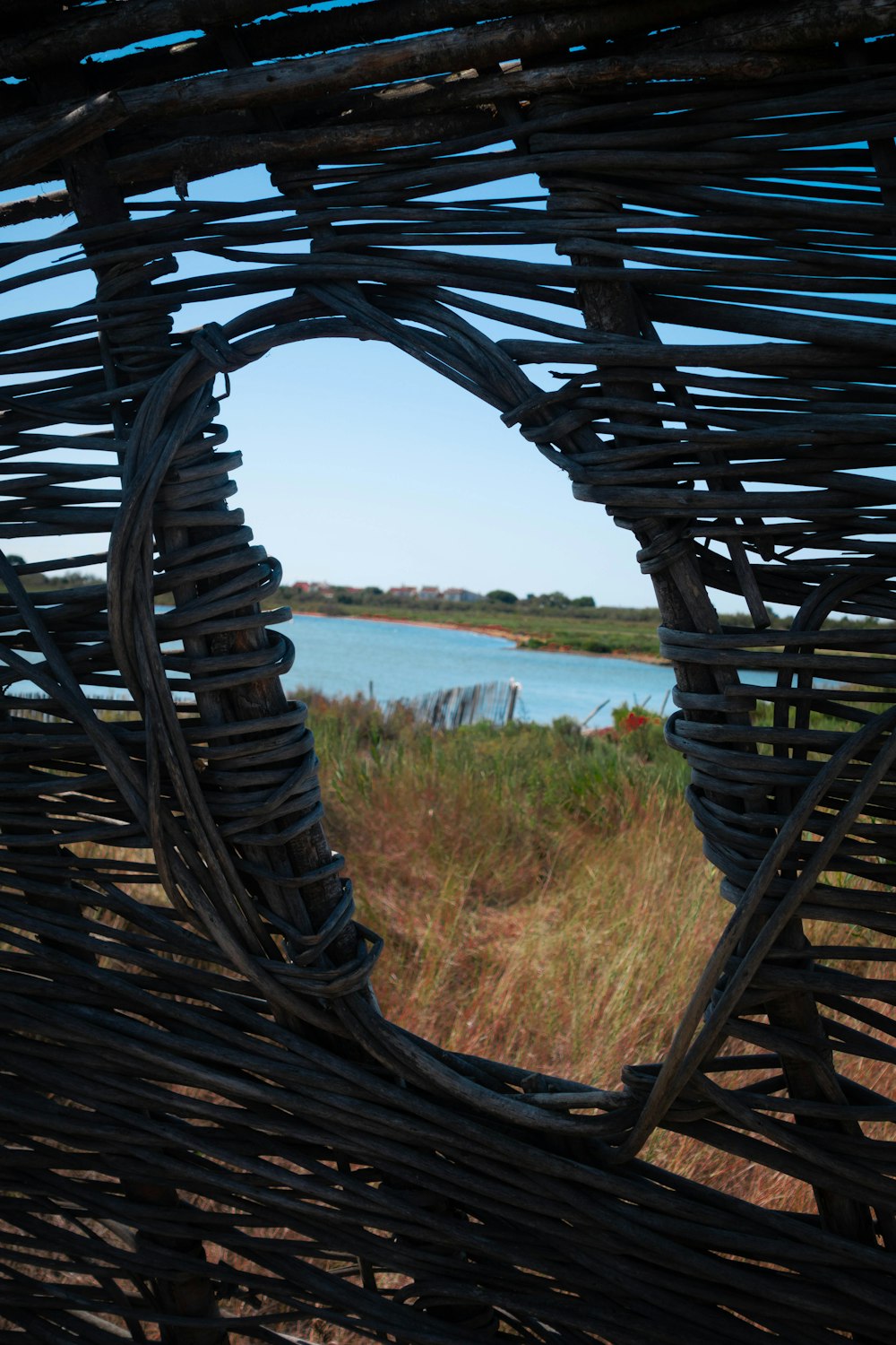 a view of a body of water through a woven basket