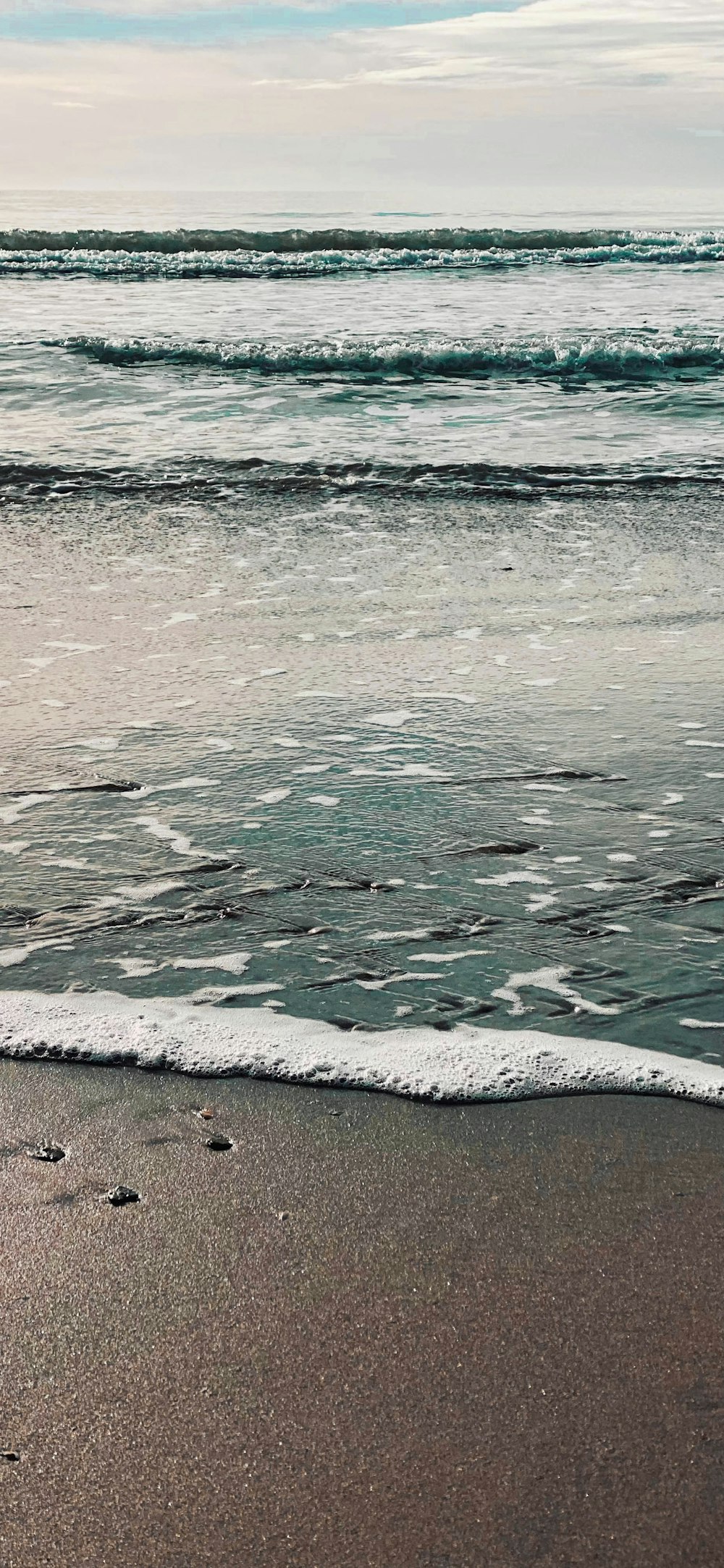 a beach with waves coming in to shore