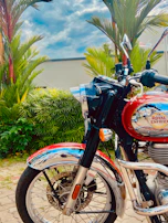 Close-up of a shiny Suzuki motorcycle with vibrant colors under natural light.