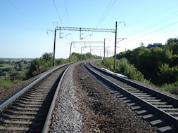 a train track with power lines above it