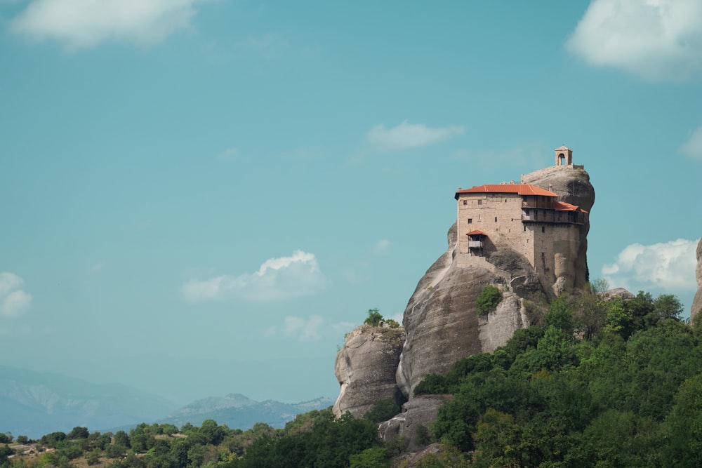 a rock formation with a house on top of it