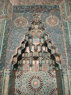 A wall decorated with vibrant Islamic art paintings featuring Quranic verses.