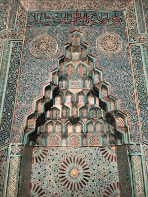 A wall decorated with vibrant Islamic art paintings featuring Quranic verses.