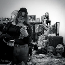 A cheerful customer service representative wearing a headset, ready to assist with toy orders.