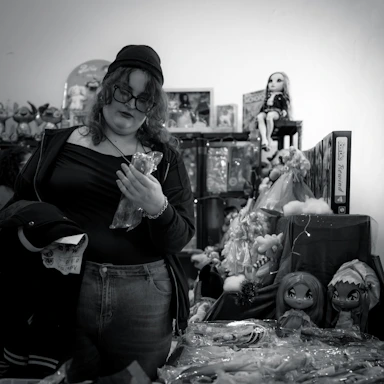 A cheerful customer service representative wearing a headset, ready to assist with toy orders.