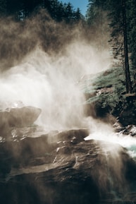 A mystical waterfall framed by ancient trees with delicate elven carvings.