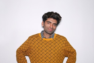 A model smiling while wearing a quirky Jane Austen inspired sweatshirt, standing against a bookshelf backdrop.