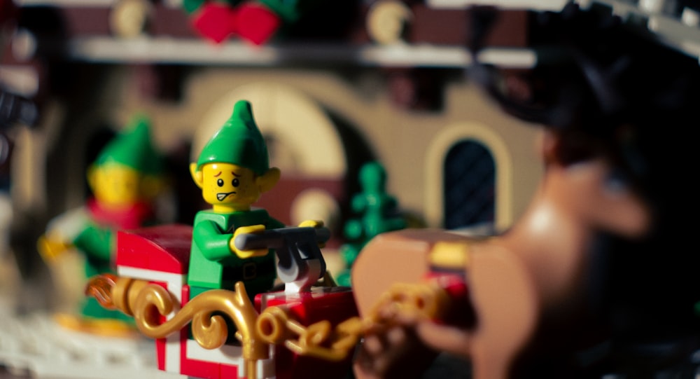 a close up of a lego man on a sleigh