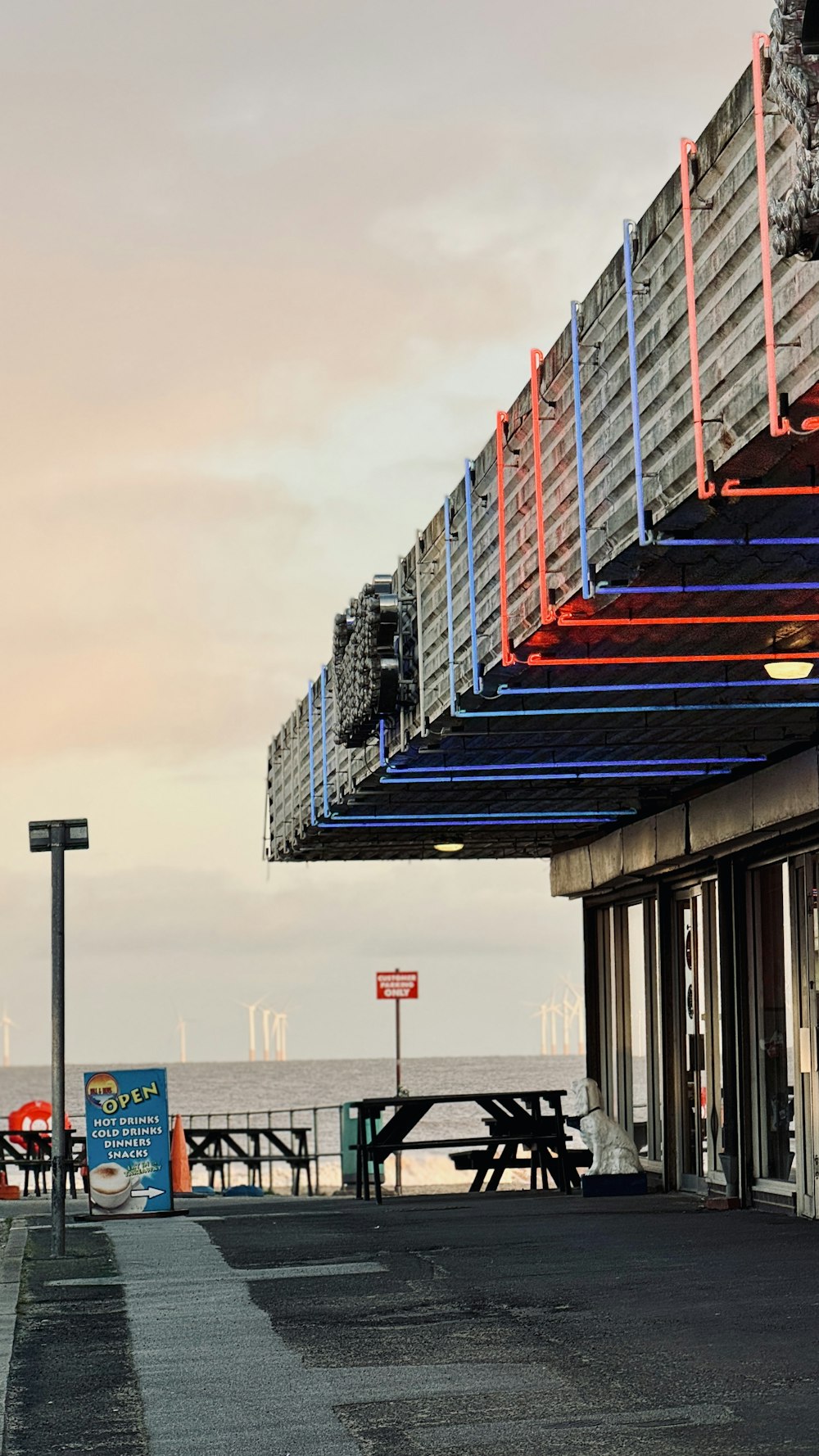 an empty parking lot next to the ocean