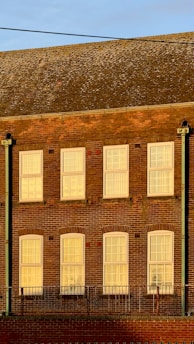 Exterior view of a building showing durable metal and brick window sills in natural light.