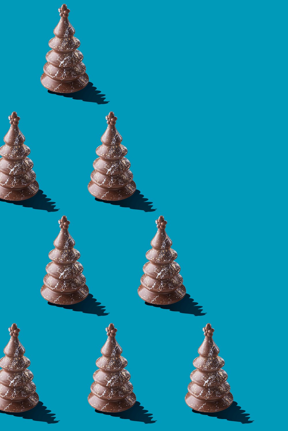 a group of small christmas trees on a blue background