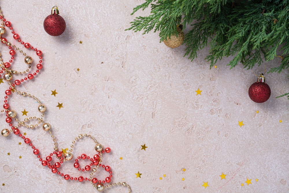 a christmas tree with ornaments and a red beaded necklace