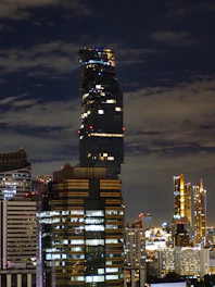 A modern city skyline with digital tokens floating above buildings.