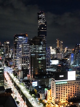 A vibrant cityscape with illuminated billboards at night.