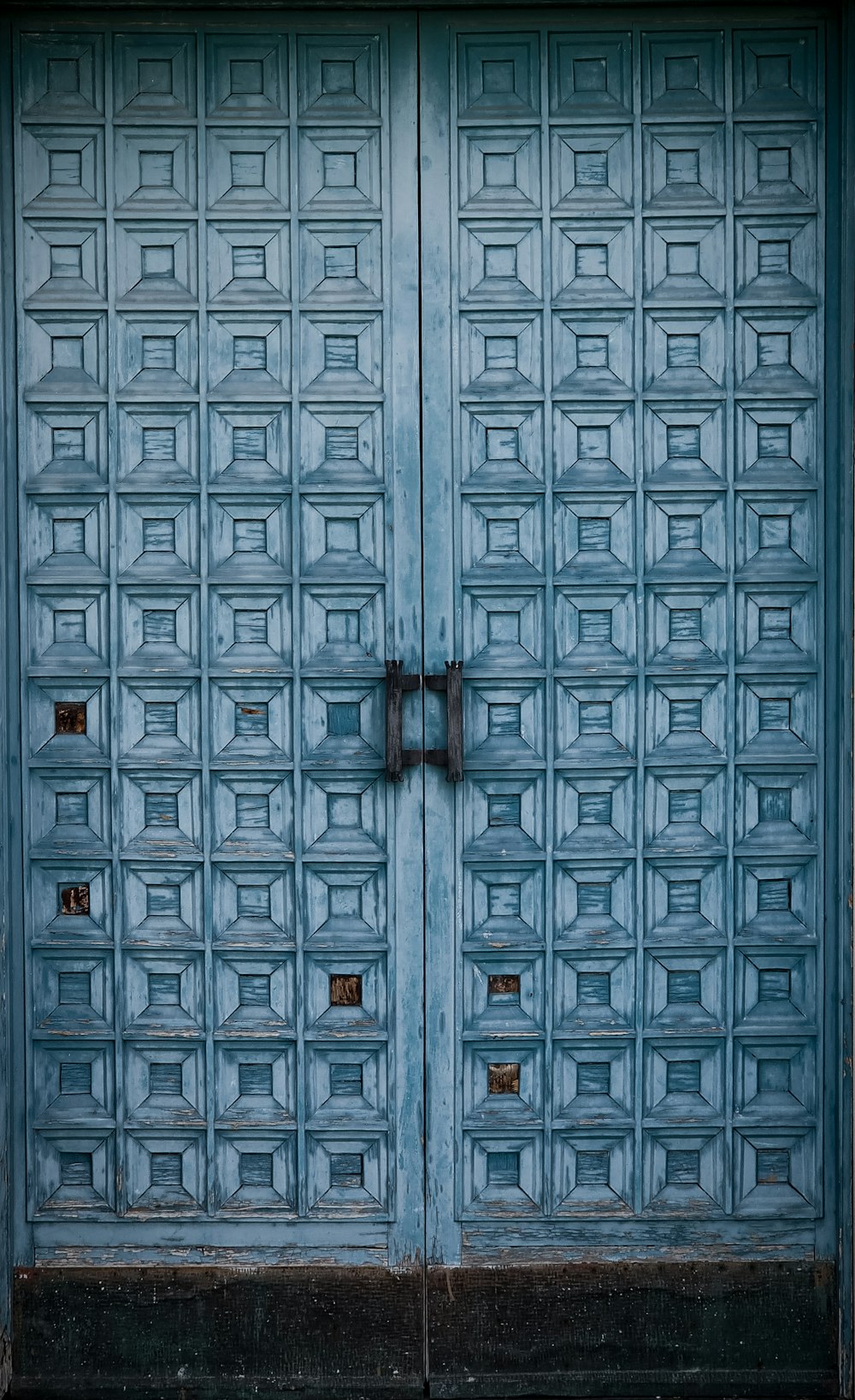 a blue door with a metal handle on it