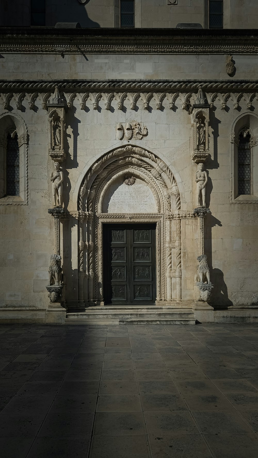 a large stone building with a black door