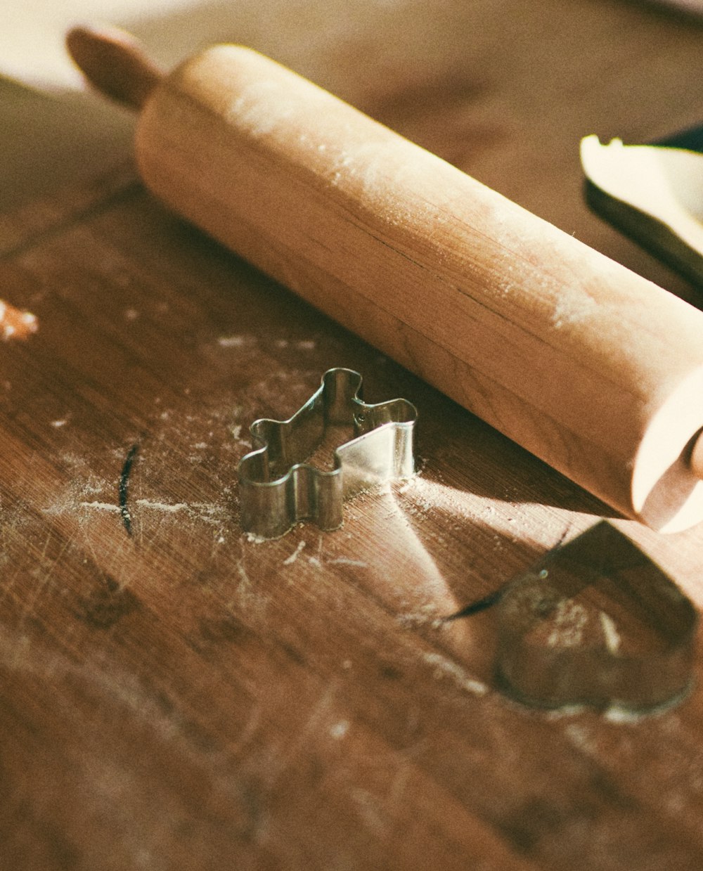 a piece of wood with a cookie cutter next to it