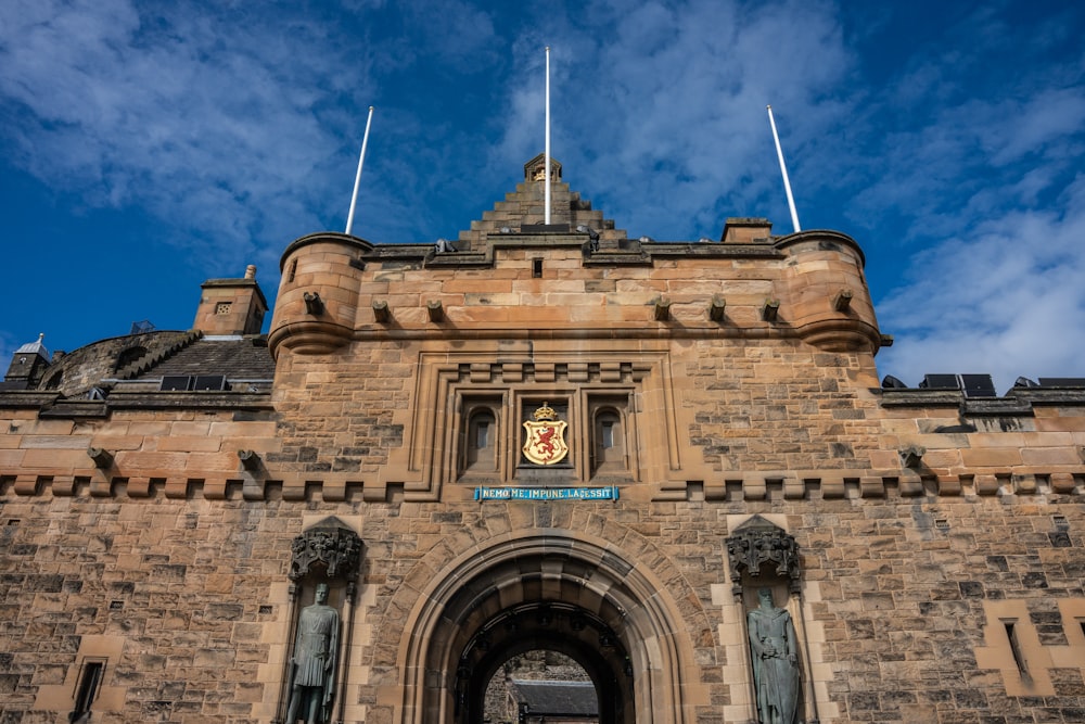 a large stone building with a clock on it's side