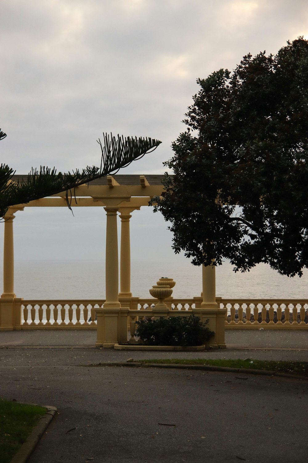 a gazebo sitting next to a lush green tree