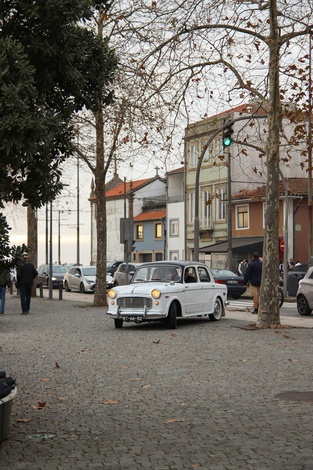 a white car parked on the side of a road