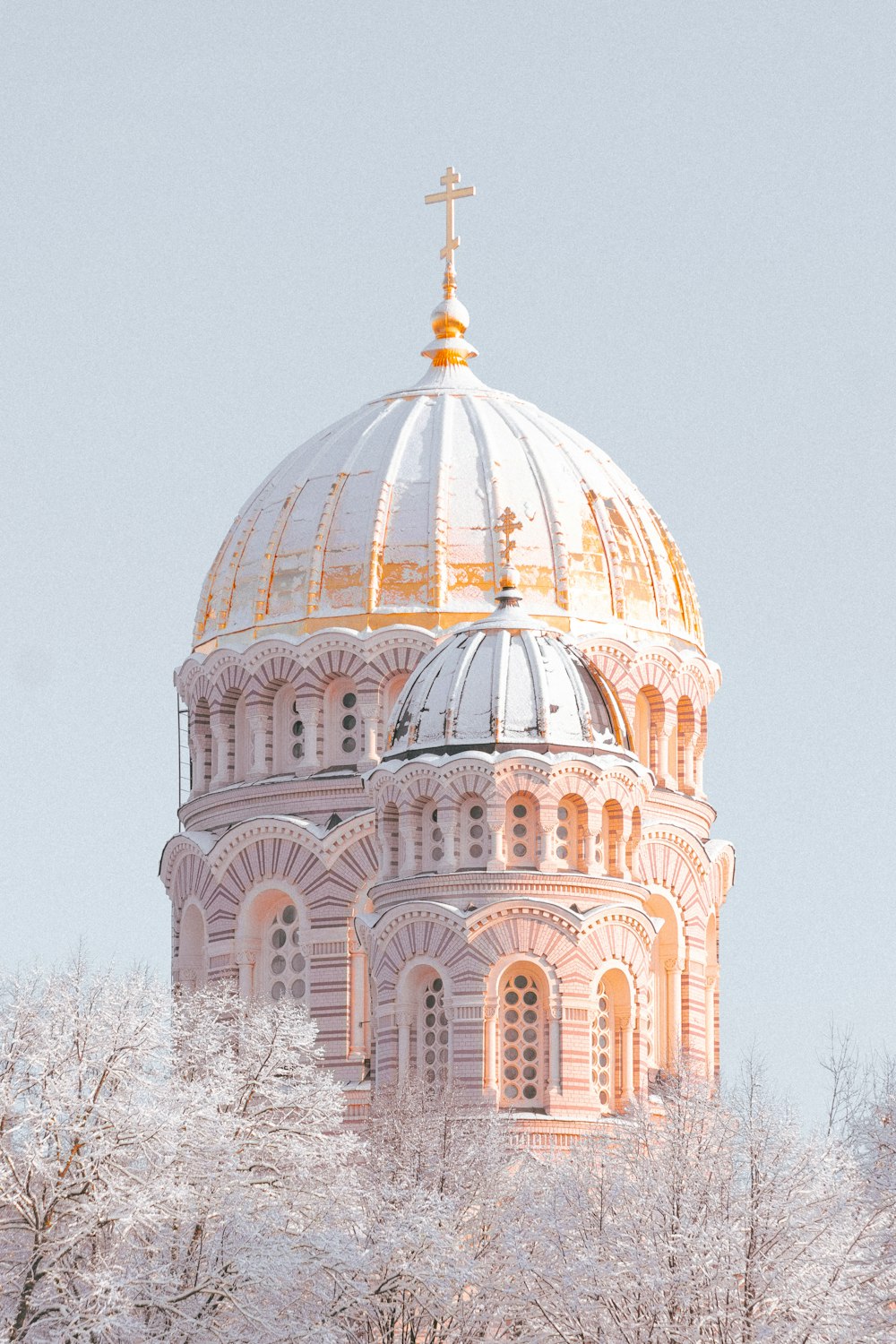 a large building with a cross on top of it