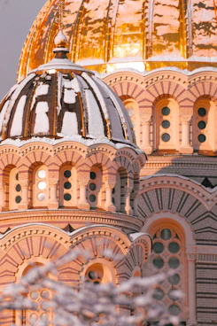 a close up of a building with a gold dome