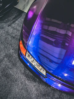 A vibrant purple and orange themed contact form interface on a modern second-hand car website.