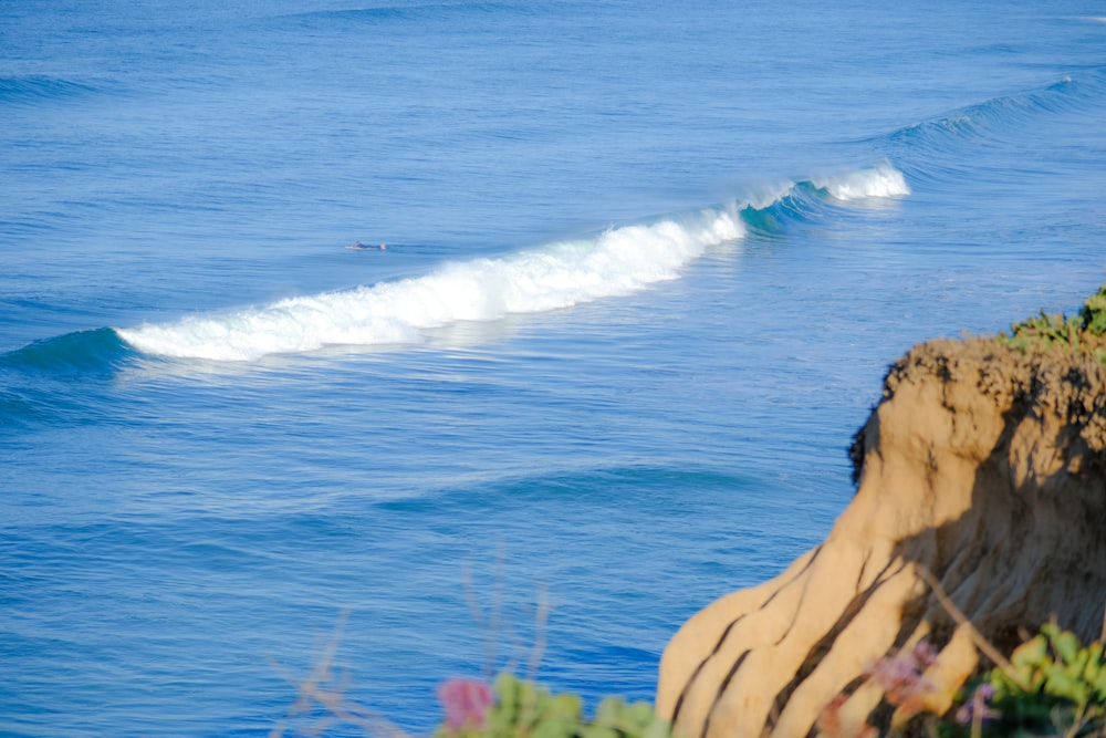 a person riding a surfboard on a wave in the ocean