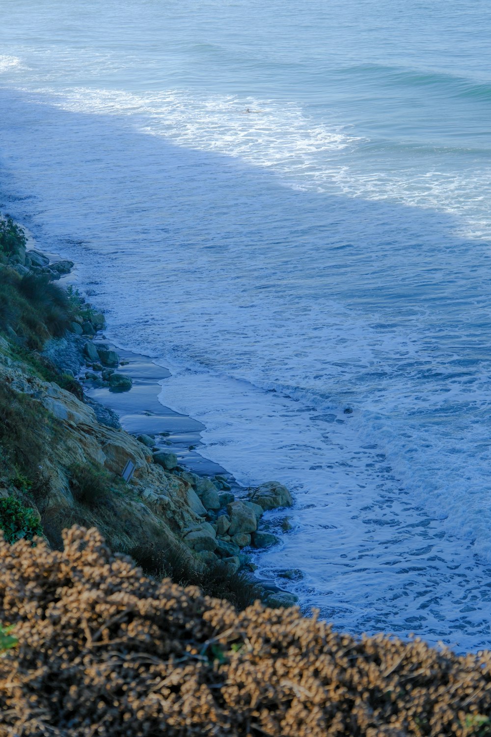 a man riding a surfboard on the side of a cliff