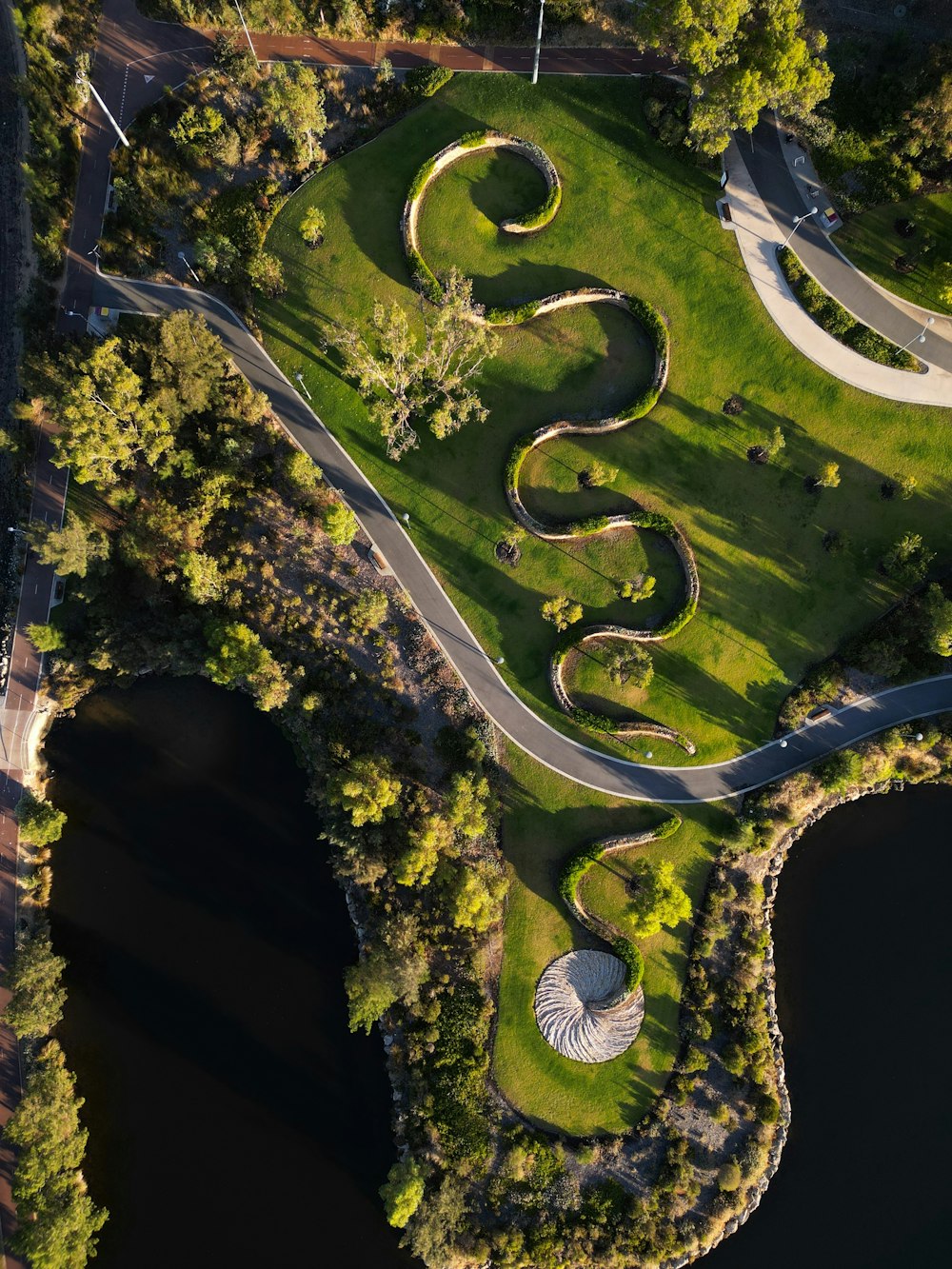 an aerial view of a park with a river running through it