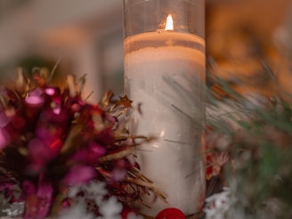 Warmly lit tabletop display featuring timeless Christmas ornaments and candles.