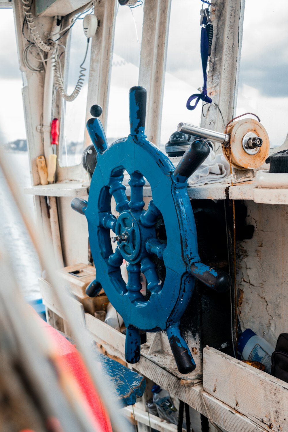 a steering wheel on a boat in the water